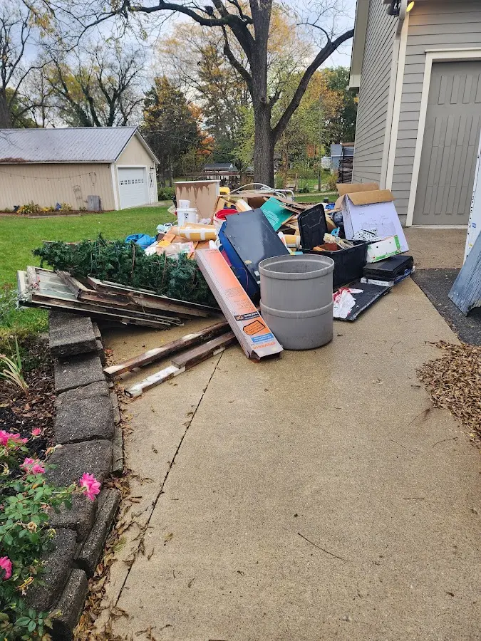 Dumpster being loaded with debris for Demolition Dumpster Rental in Winona Lake